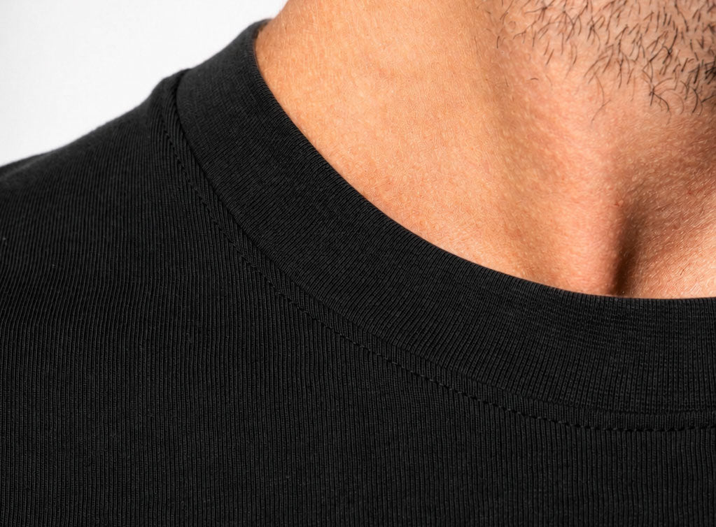 Rib-knit crew neck collar with reinforced stitching on oversized cotton t-shirt