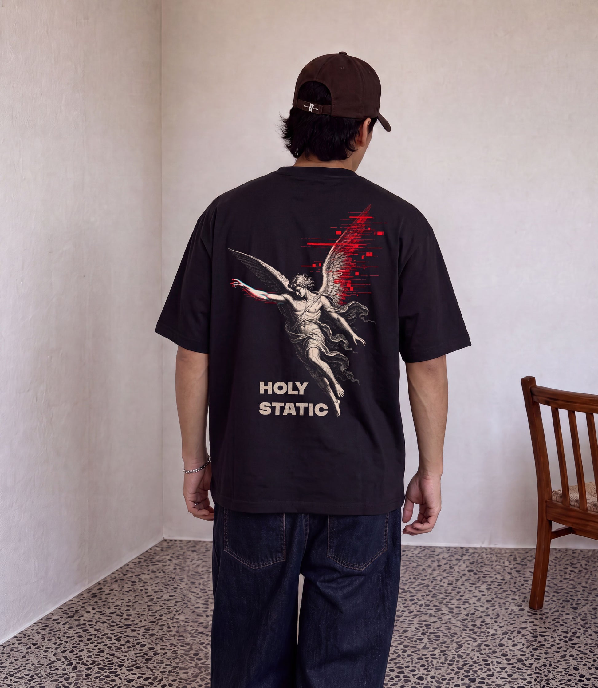 Holy Static black oversized tee with sacred figure dissolving into static graphic