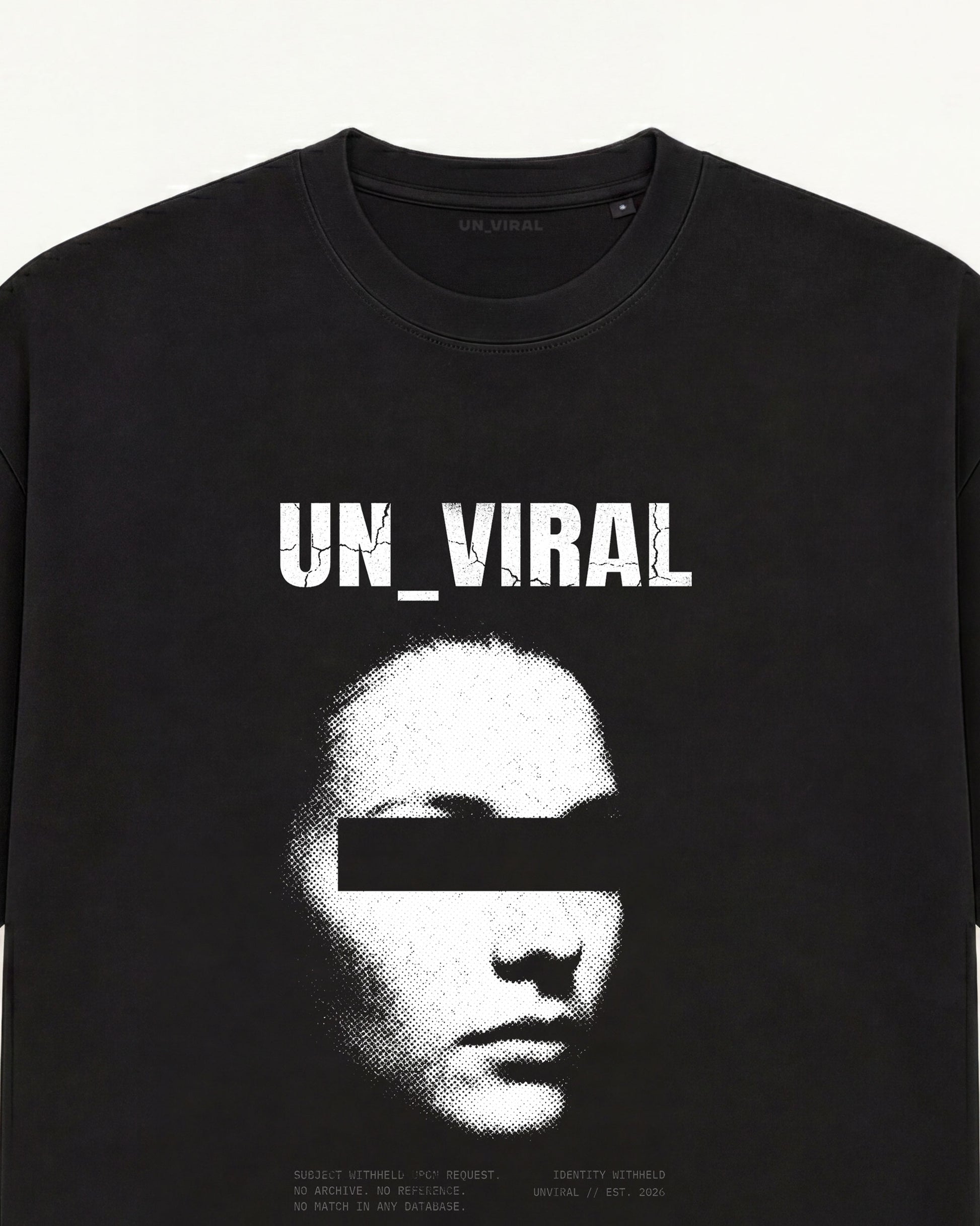 Identity Withheld tee in black with redacted portrait and censorship bar over the eyes  