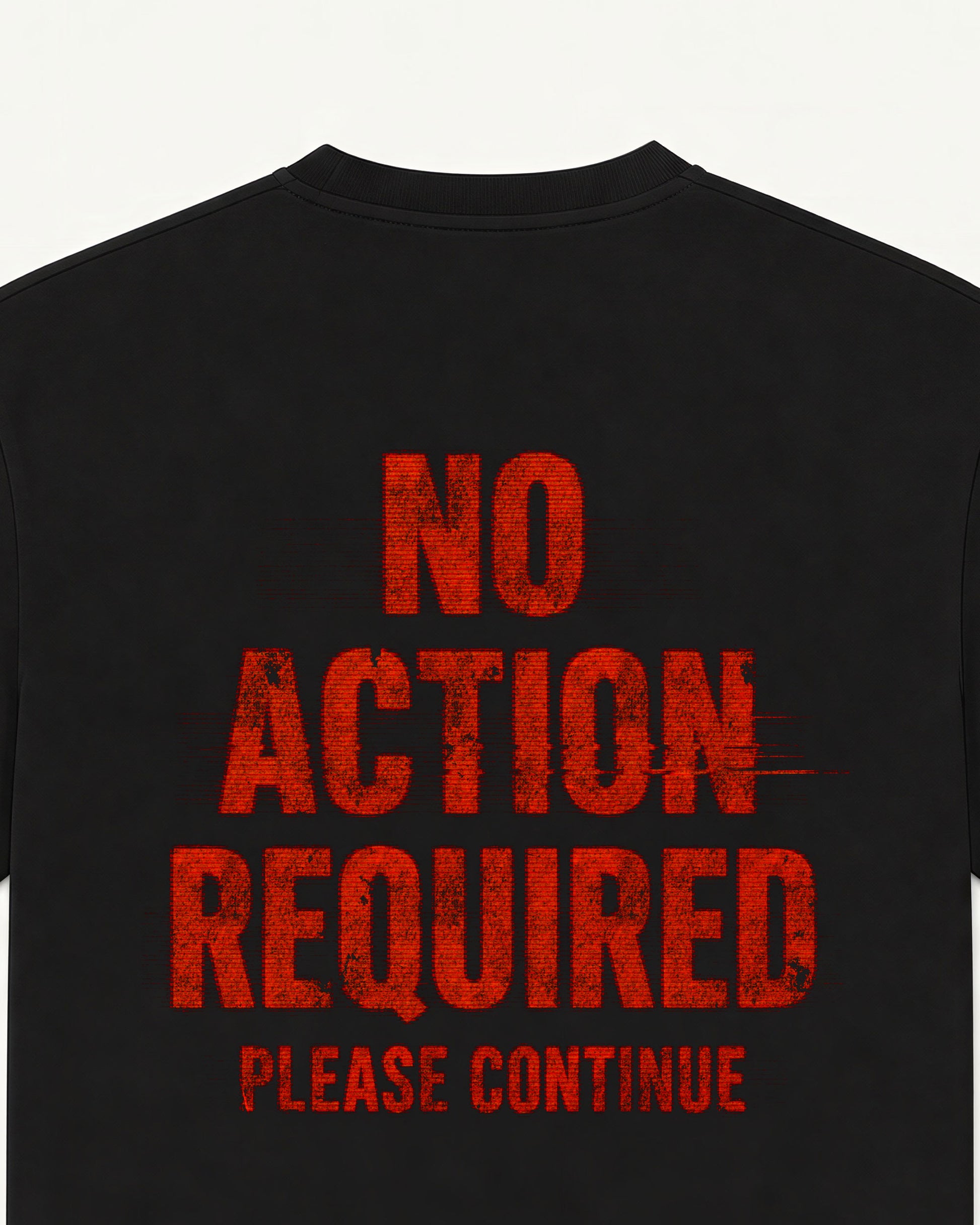 Close-up of the No Action Required back print on a black oversized UN_VIRAL tee, distressed poster type