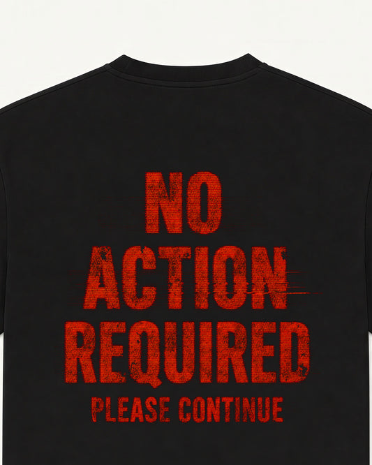 Close-up of the No Action Required back print on a black oversized UNVIRAL tee, distressed poster type
