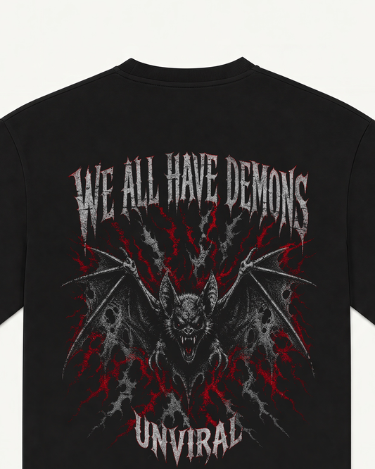 Close-up of the We All Have Demons bat illustration back print on a black oversized UNVIRAL tee
