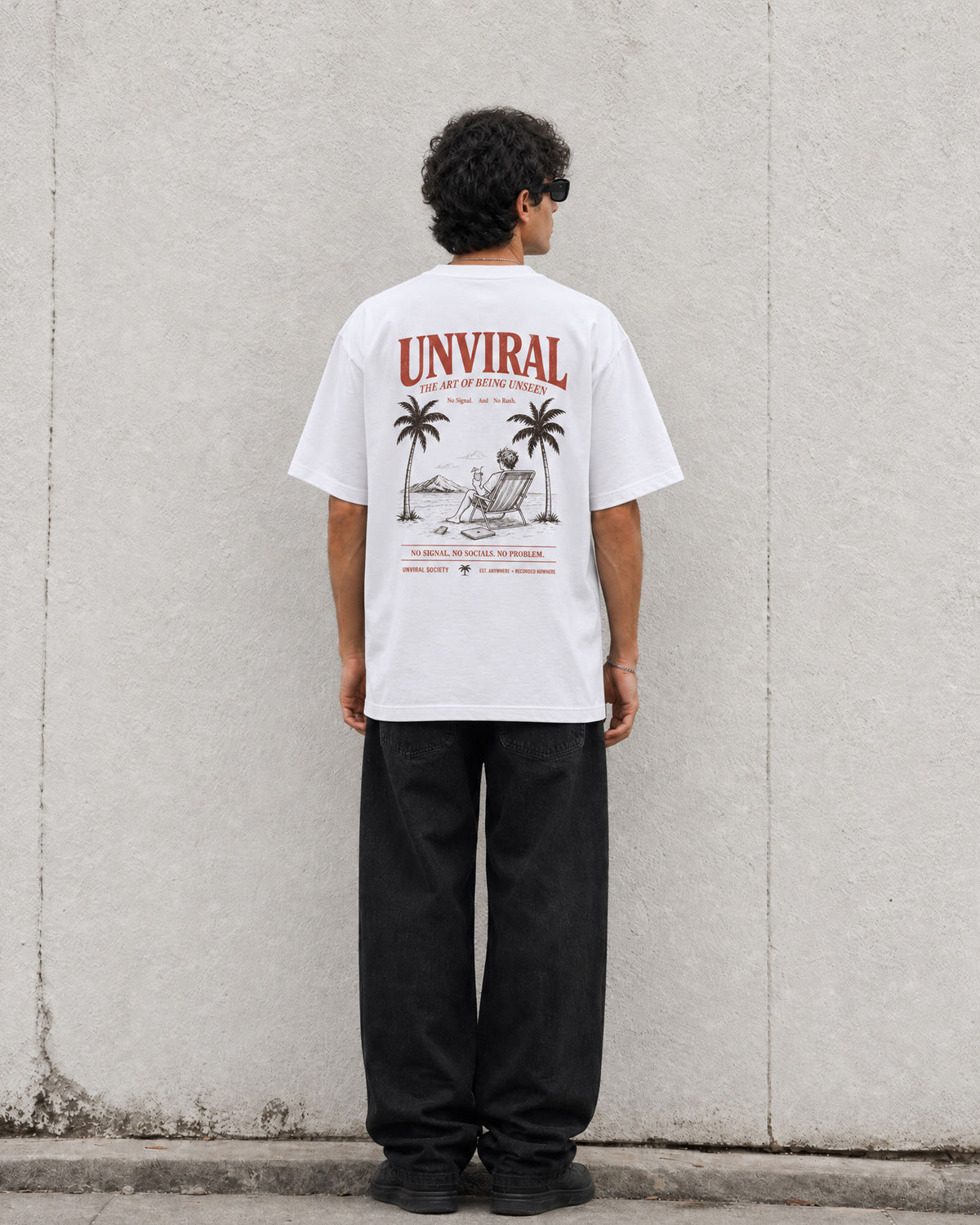 The Art of Being Unseen white oversized tee worn on model, back print visible