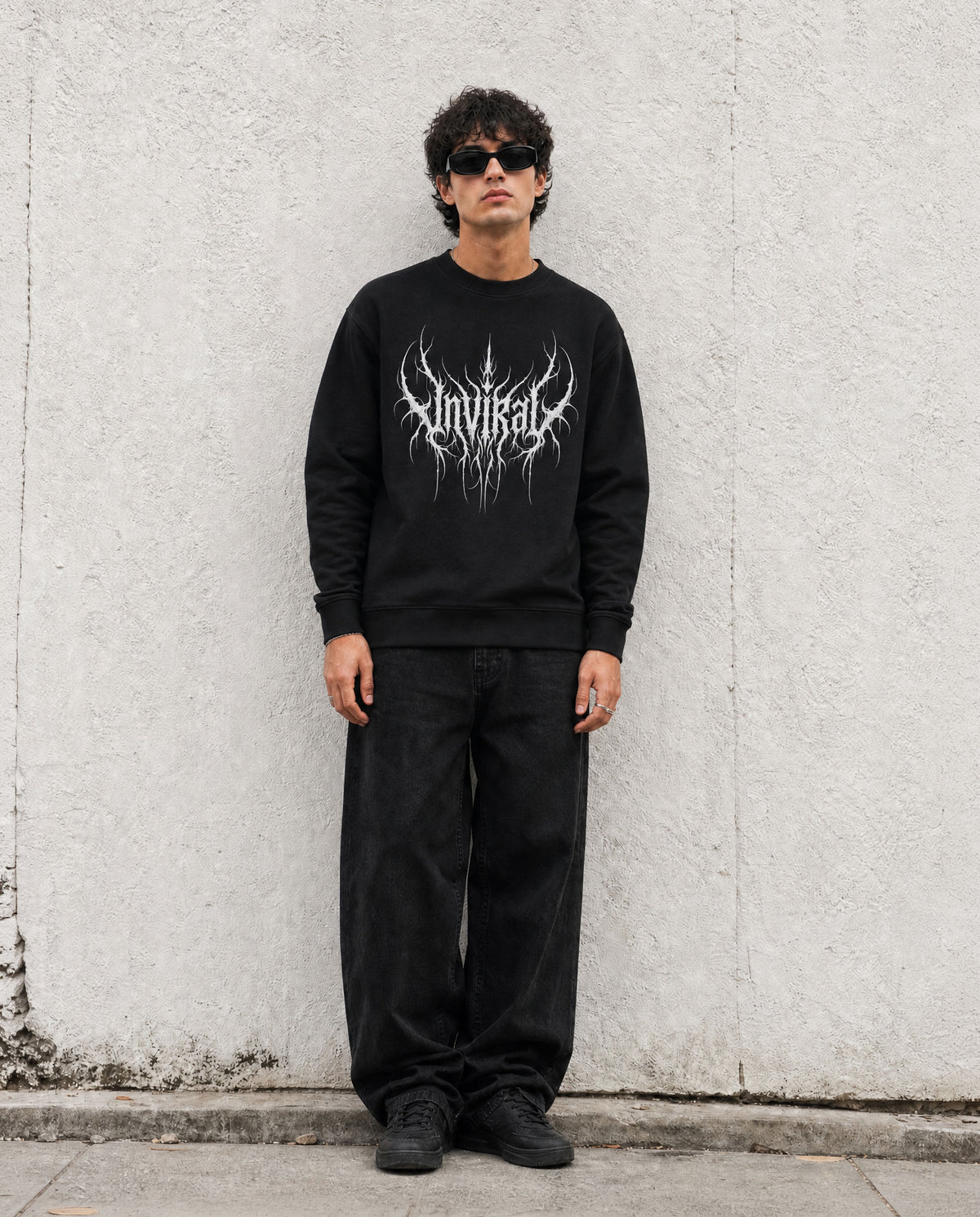 Rootbound UNVIRAL black sweatshirt worn on model, detail