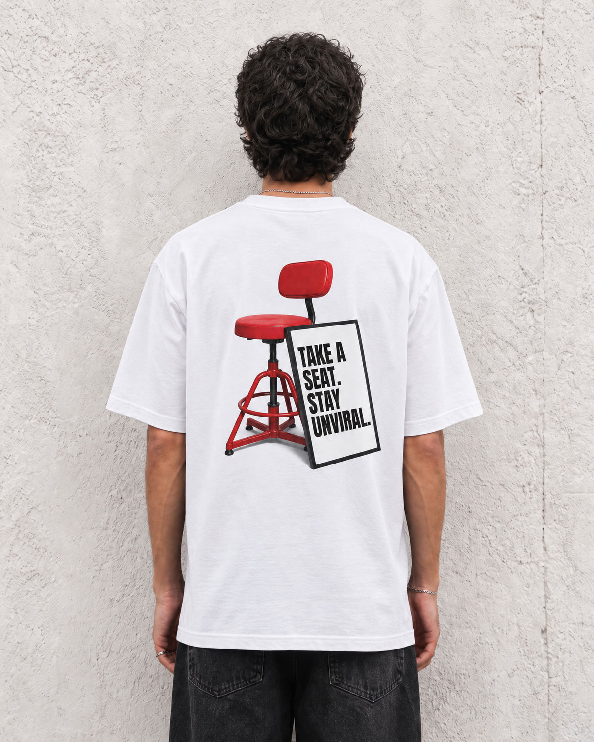 Take a Seat white oversized tee worn on model, back print visible