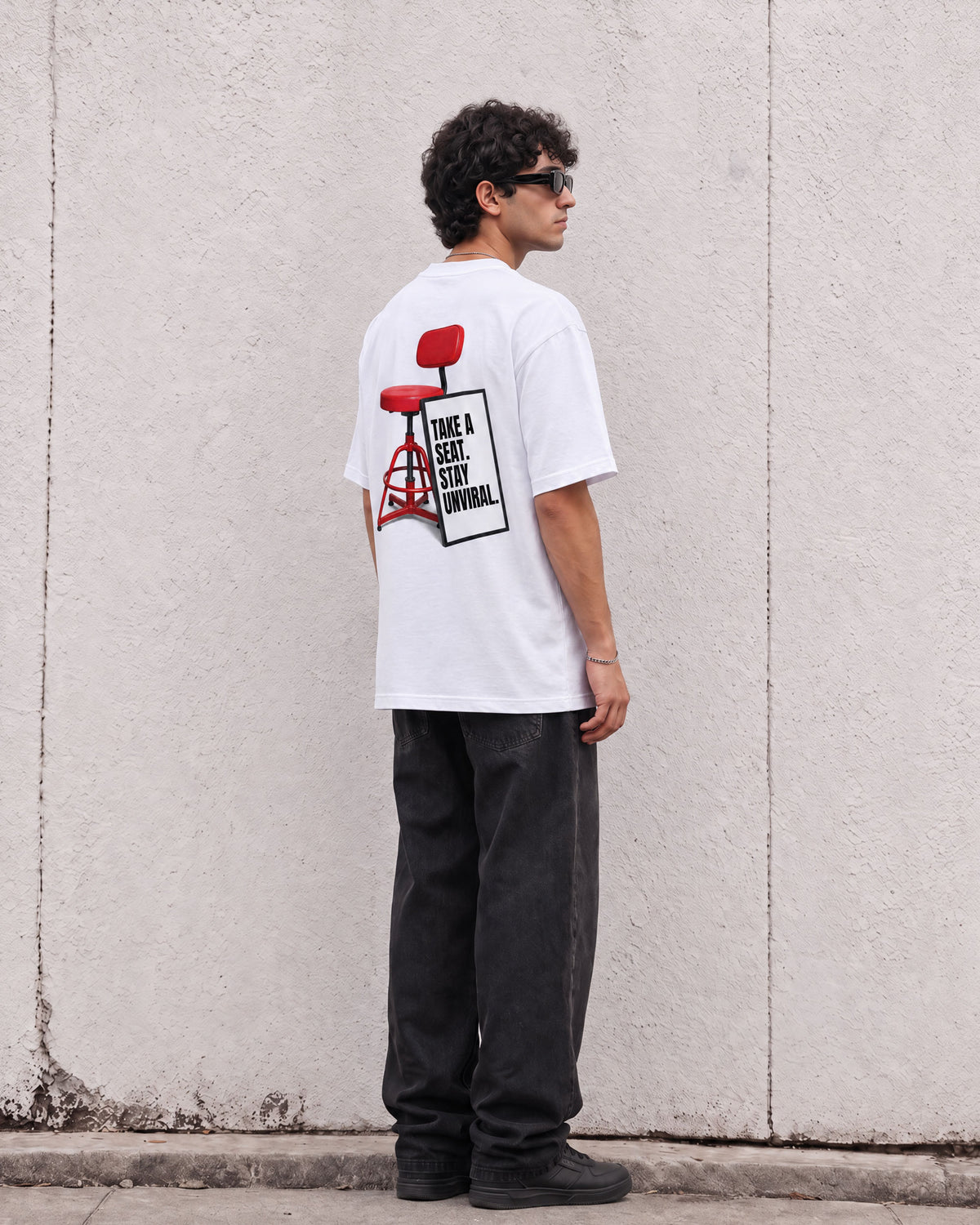 Take a Seat white oversized tee worn on model, detail