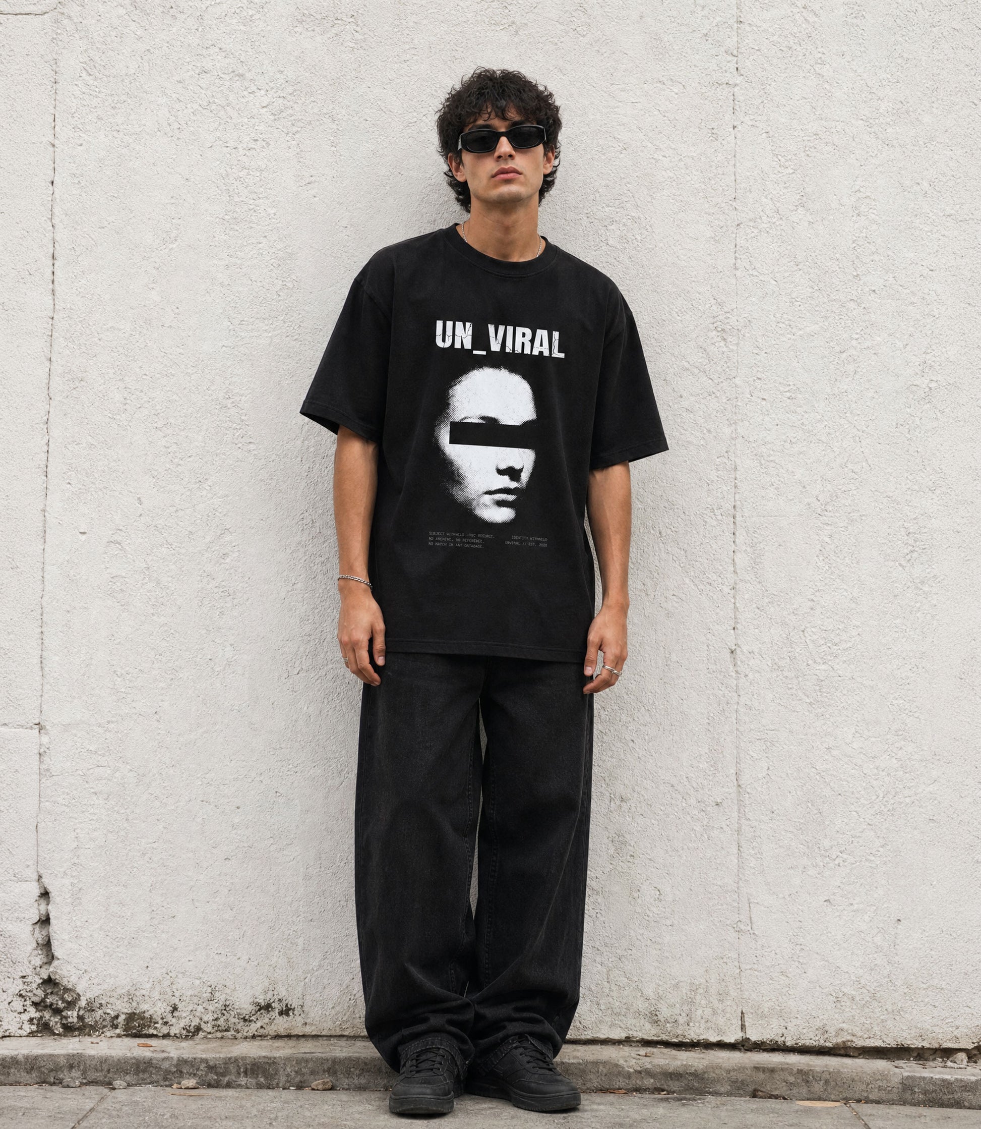 Identity Withheld black oversized tee with redacted portrait and censorship bar graphic