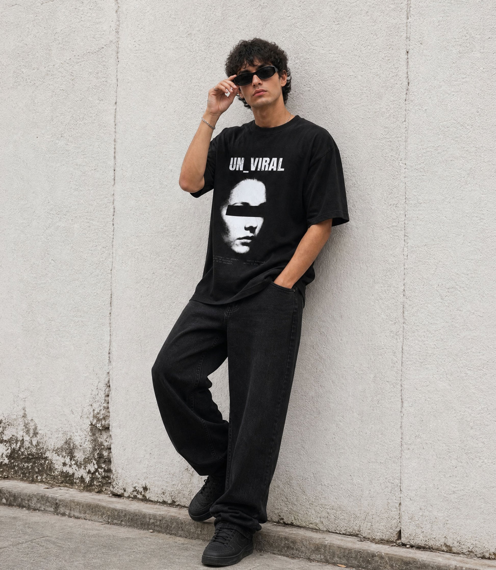 Identity Withheld black oversized tee with redacted portrait graphic