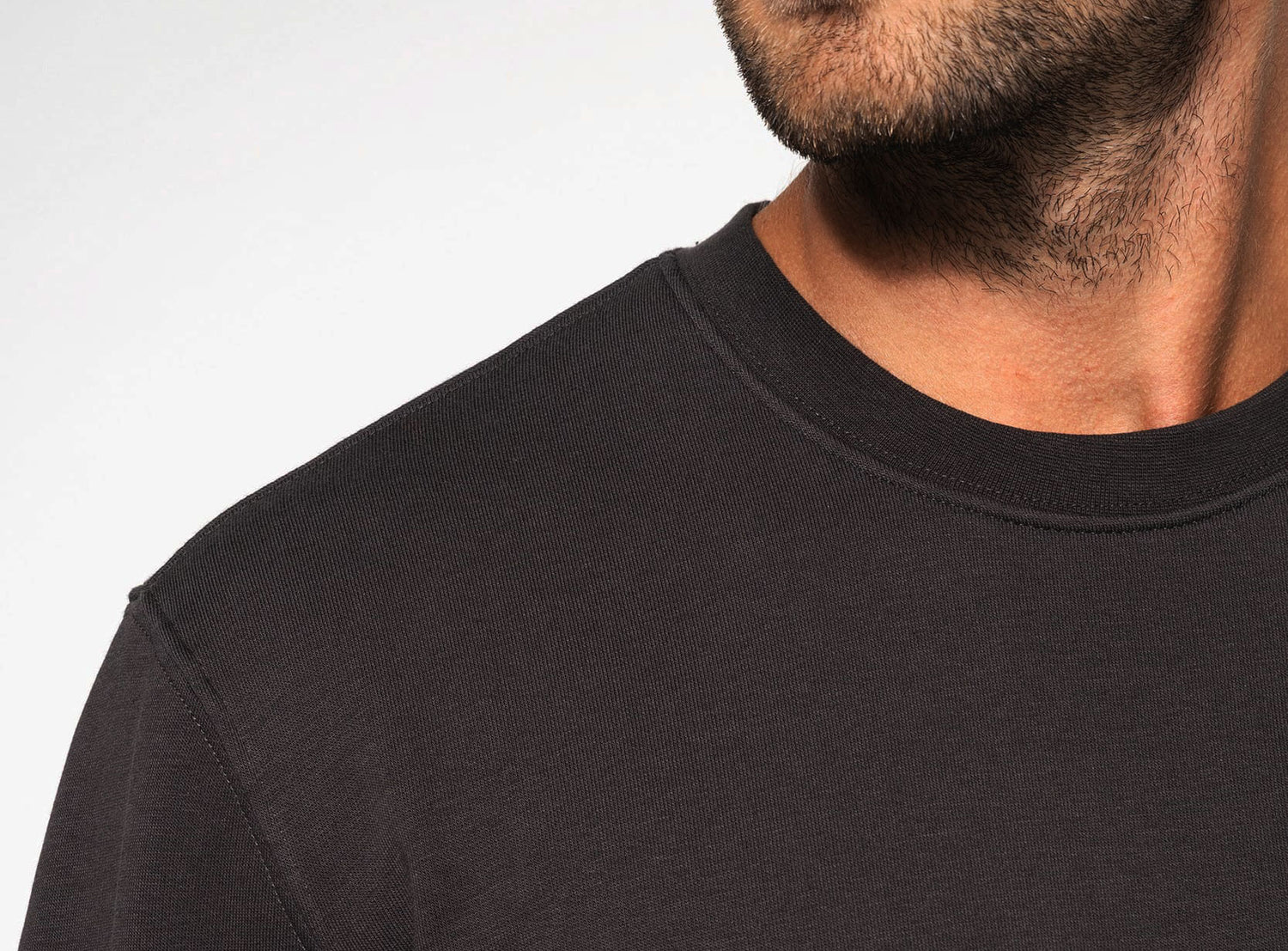 Close-up of UNVIRAL 280gsm organic cotton sweatshirt showing fabric texture and shoulder construction.
